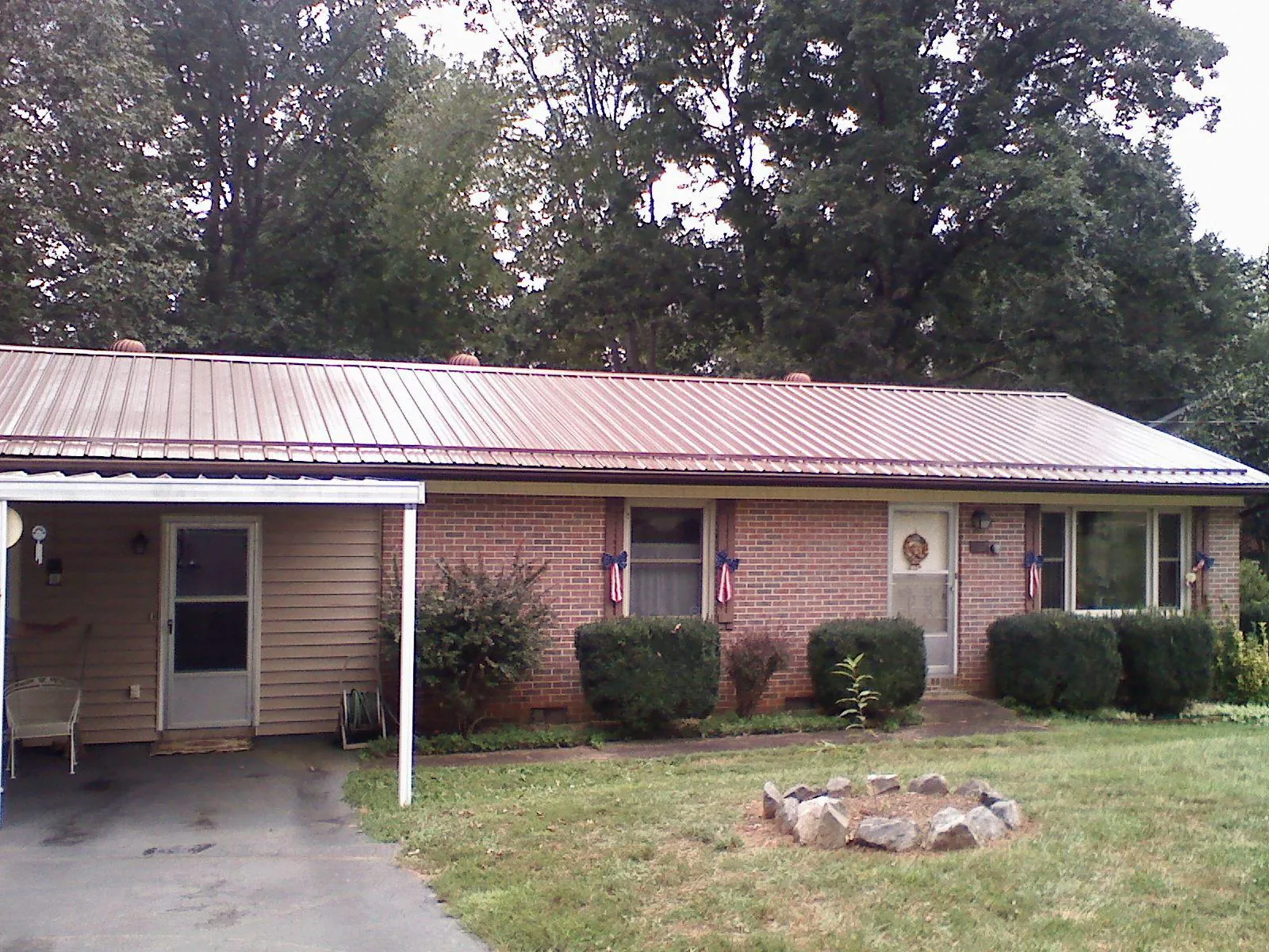 Bronze metal roof and carport on a brick ranch home — Roof Repair work by our crew in Nassau